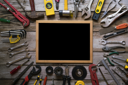 Old tools equipment with blackboard on wood table background, engineering conceptの写真素材