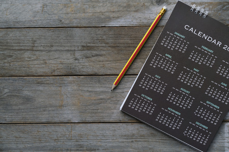close up of calendar and pencil on the table, planning for business meeting or travel planning conceptの写真素材