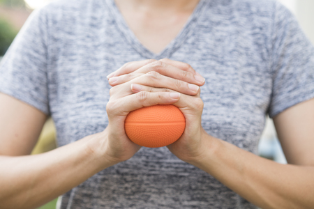 hand of woman holding stress ball の写真素材