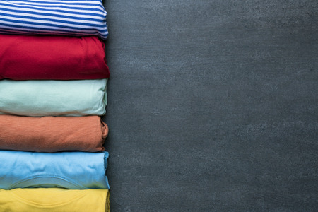 close up of rolled colorful clothes on black backgroundの写真素材