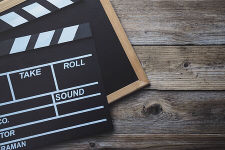 movie clapper on wood table ; film, cinema and video photography conceptの写真素材