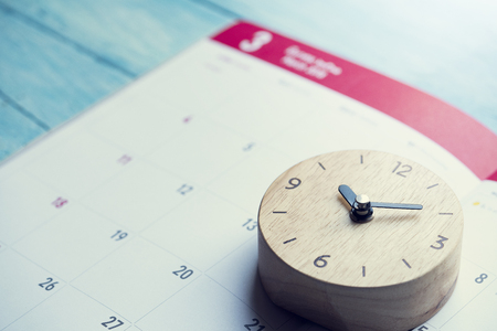 close up of calendar and clock on the table, planning for business meeting or travel planning conceptの写真素材