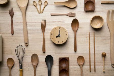 kitchen utensils and clock for cooking on the wooden table, time for food prepare conceptの写真素材