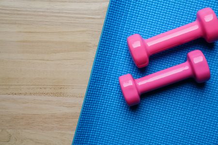 dumbbell and yoga mat on table, fitness healthy and sport conceptの写真素材
