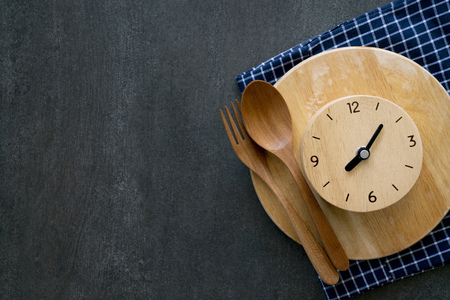 Food clock. Healthy food concept on black table backgroundの写真素材