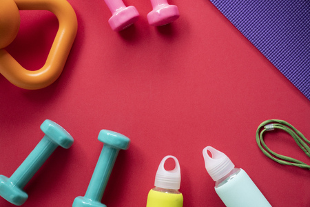 Time for exercising sport equipment, dumbbell, kettlebell and yoga mat background