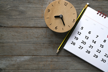 close up of calendar and clock on the table, planning for business meeting or travel planning conceptの写真素材