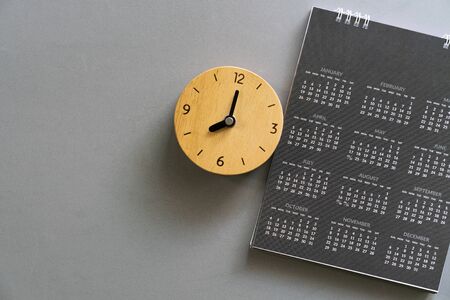 close up of calendar and clock on the gray table background, planning for business meeting or travel...