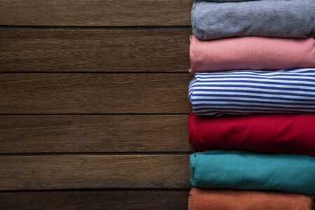 close up of rolled colorful clothes on table backgroundの写真素材