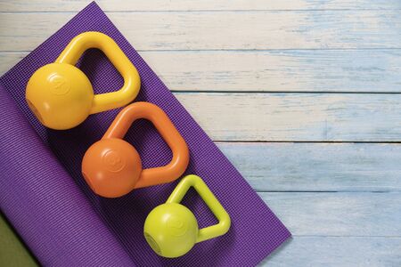 Kettlebell and yoga mat on table, fitness healthy and sport conceptの写真素材