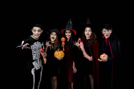 Young Asian people, a group of five persons, in scary costumes. Group of friends having fun at a party in a nightclub to celebrate Halloween festival.の写真素材