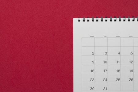 close up of calendar on the red table background, planning for business meeting or travel planning conceptの写真素材