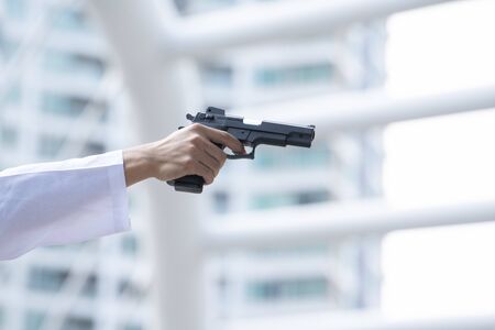 Hand of terrorist holding a gun