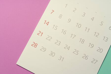close up of calendar on the pink and green table, planning for business meeting or travel planning...