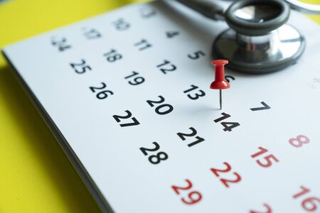 Close up of calendar and stethoscope for Covid-19, Corona Virus epidemic worldwide that people must do social distancing for 14 days conceptの写真素材