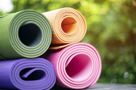close up of colorful yoga mat on the table, sport and healthy conceptの写真素材