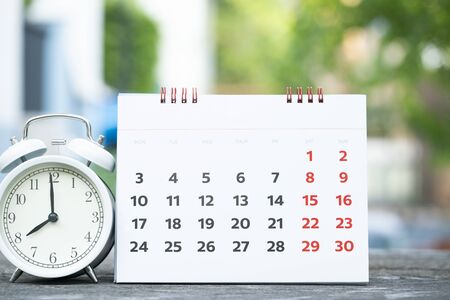 close up of calendar and alarm clock on the table, planning for business meeting or travel planning...