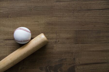 baseball and baseball bat on wooden table background, close upの写真素材