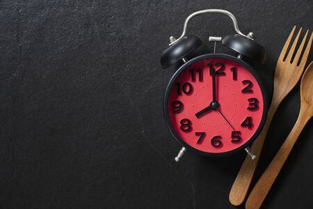 Food clock. Healthy food concept on black table backgroundの写真素材