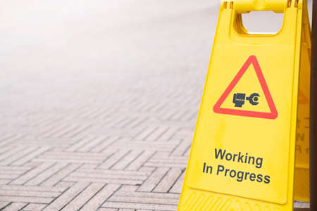 close up of warning sign for working in process, caution and dangerous