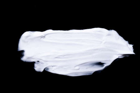 various strokes of shaving white cream on black backgroundの写真素材