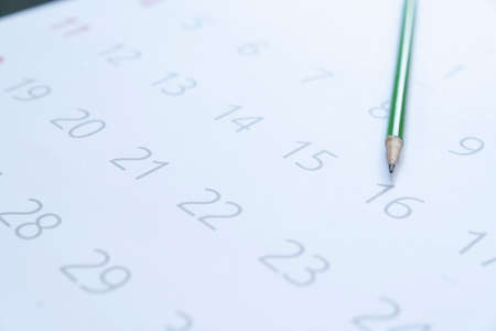 close up of calendar and pencil on the table, planning for business meeting or travel planning conceptの写真素材