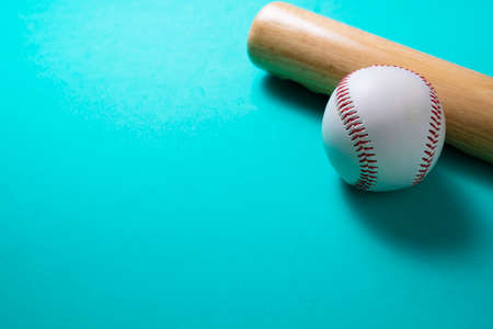 baseball and baseball bat on green table background, close upの写真素材