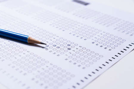 close up blue pencil on answer sheets, education exam or quiz conceptの写真素材