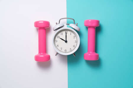 Time for exercising alarm clock and dumbbellの写真素材