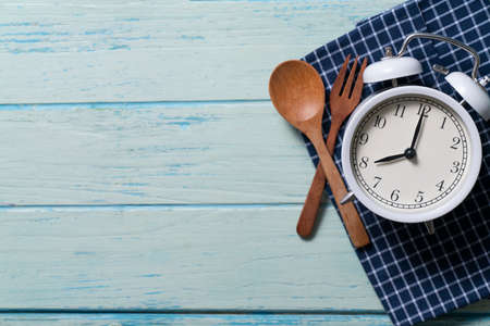 Food clock, healthy food time concept on blue table backgroundの写真素材