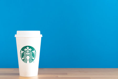 Bangkok, Thailand -JAN 24, 2021: Close up a cup of Starbuck coffee on the table with blue backgroundのeditorial素材
