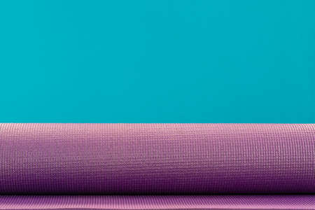 close up of purple yoga mat on the table with green background, sport and healthy conceptの写真素材