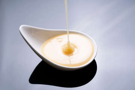 close up of condensed milk isolated on the table background, food and dessert conceptの写真素材