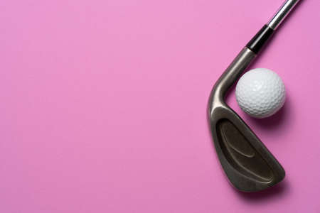 golf ball and golf club on pink table background, sport conceptの写真素材
