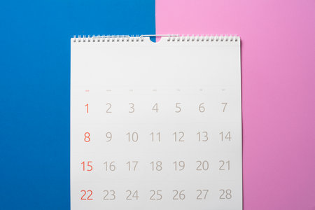 close up of calendar on the pink and blue table background, planning for business meeting or travel planning conceptの写真素材