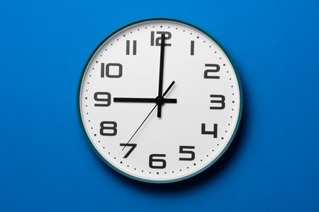 Retro clock on blue table background, vintage styleの写真素材