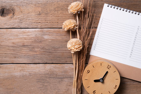 close up of clock and calendar on the wooden table background, planning for business meeting or travel planning conceptの写真素材