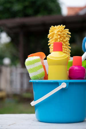 House cleaning product on wood table, home service or housekeeping concept