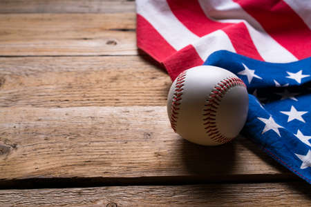 close up baseball with American flag on the wooden table background