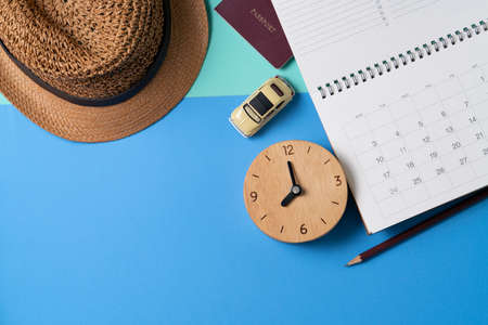 concept of travel vacation trip and long summer weekend planning, calendar, passport, clock on blue...