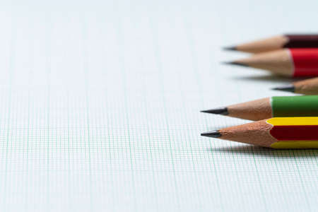 pencils on graph paper, research and education concept