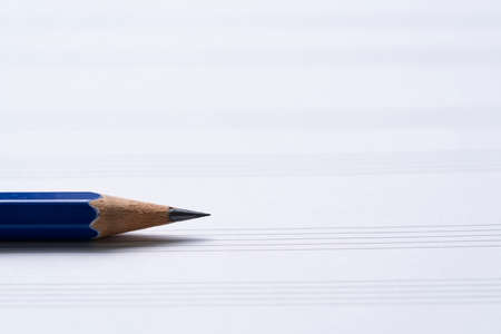 close up a pnecil and music sheet on the table background, music instrument conceptの写真素材