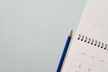 close up of pencil and calendar on the graph paper background, planning for business meeting or...