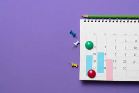 close up of calendar on the purple table background, planning for business meeting or travel planning conceptの写真素材