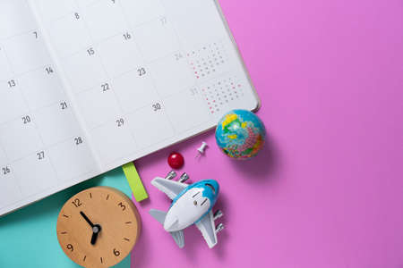 concept of calendar travel vacation trip and long summer weekend planning on pink table backgroundの写真素材