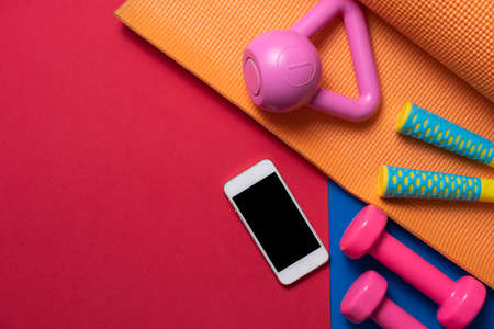 Time for exercising sport equipment with yoga mat background