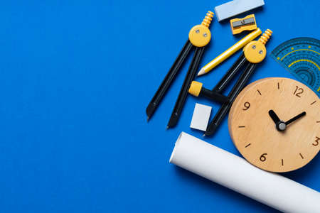 engineer or architect desk with stationery and clock on blue background in the office, project ideas conceptの写真素材