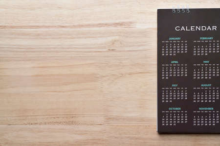 close up of calendar on wooden table background, planning for business meeting or travel planning...