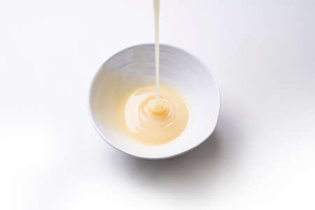 condensed milk isolated on a white backgroundの写真素材