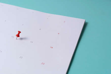close up of pin on calendar on the green table background, planning for business meeting or travel planning conceptの写真素材